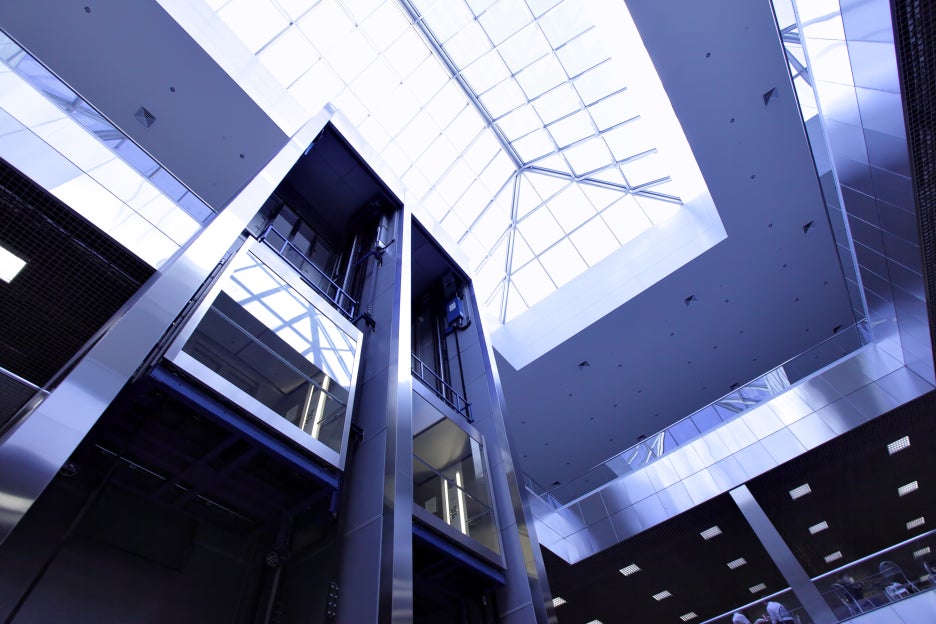 The interior of a building with a glass elevator shaft installed