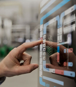 A worker operating a touch panel on the production line